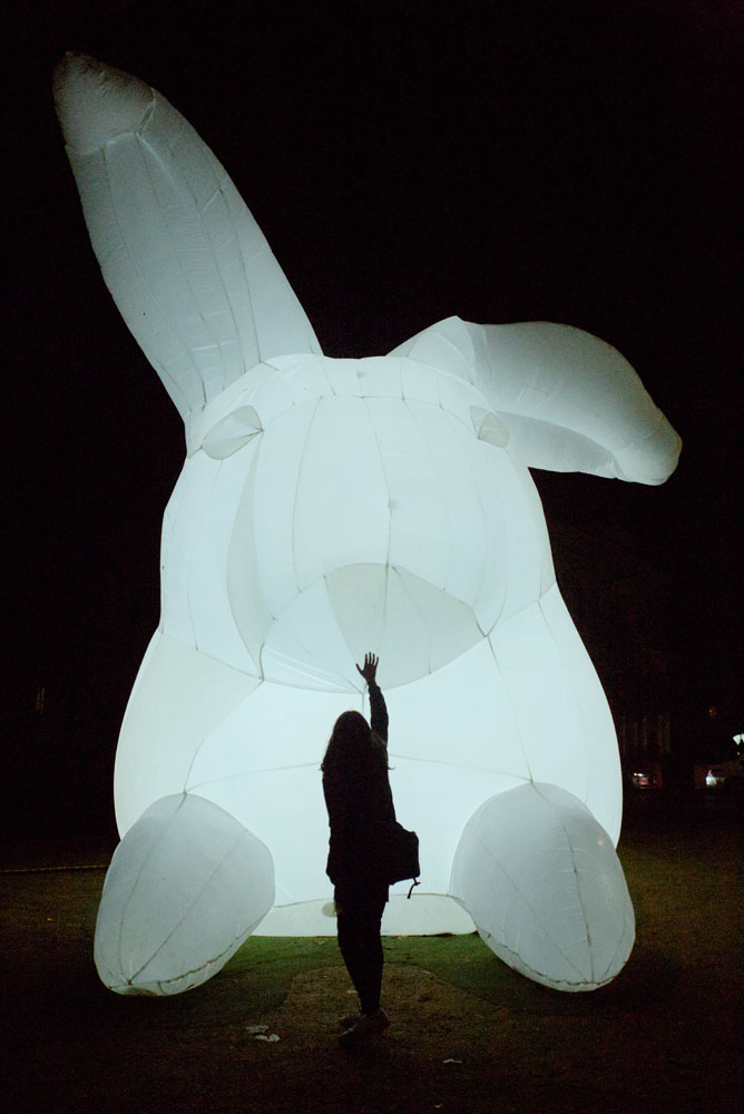 A photo of my partner silhouetted against a giant inflatable bunny, taken at 24mm.
